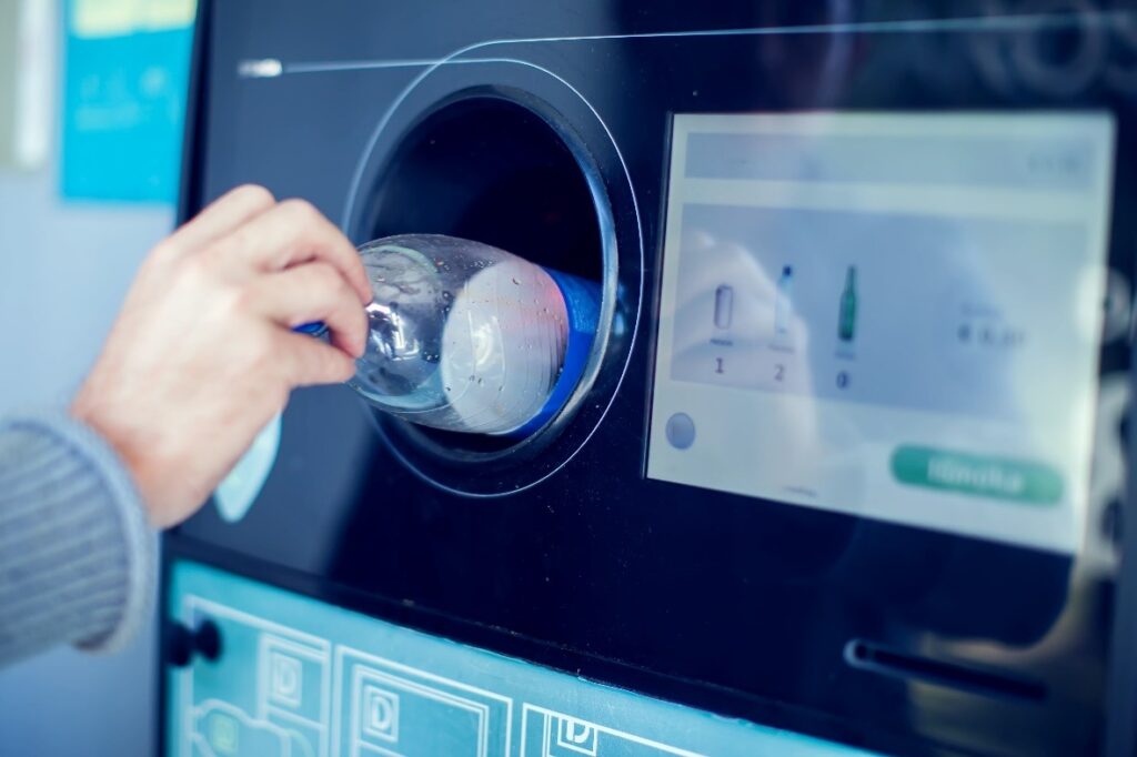 shoppers return their bottles and cans in a reverse vending machine