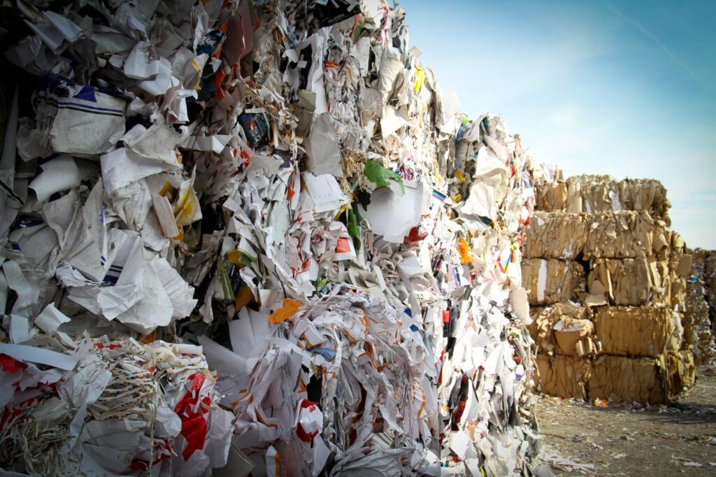 stack of shredded paper at recycling plant