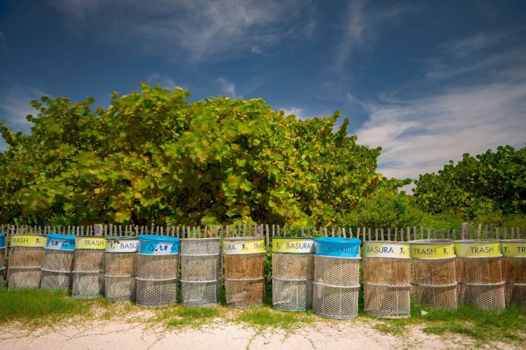trash and recycling bins on the beach