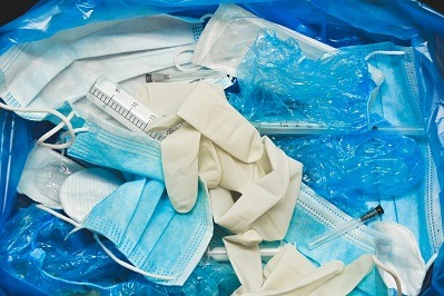 Coronavirus protection equipment in medical waste bin