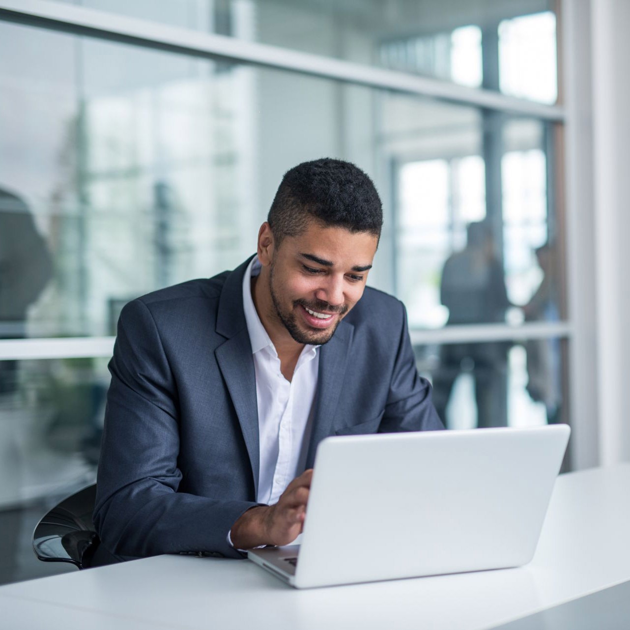 man using laptop in office building