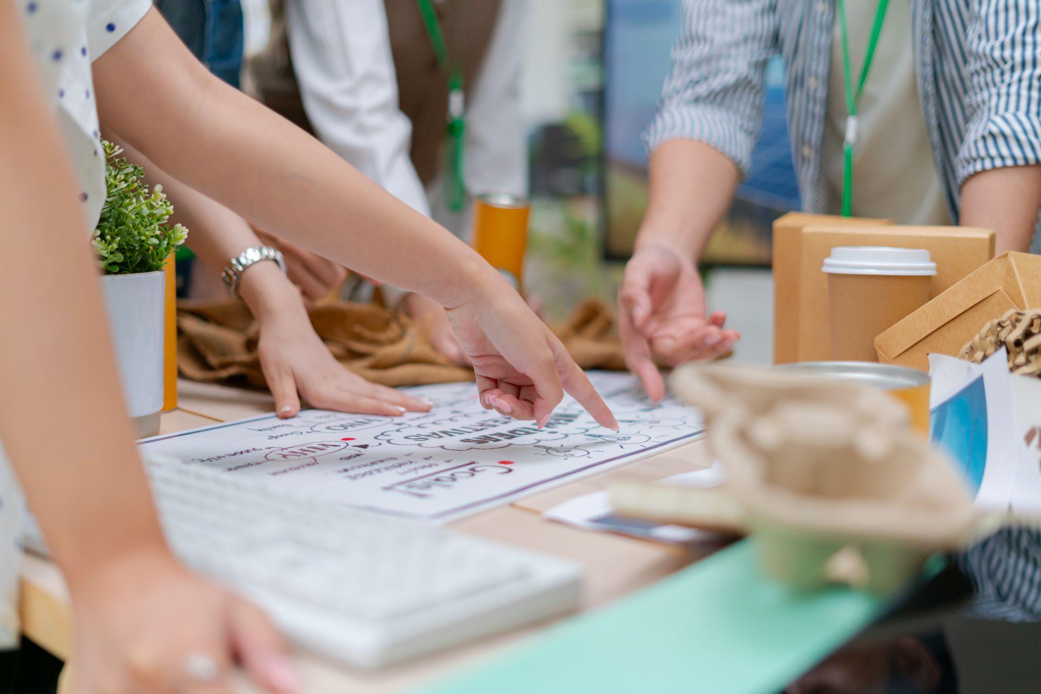 Young Asian business team discussion reusable product in office,start up eco-friendly business,environmental protection,sustainable business model,ESG strategy,team meeting