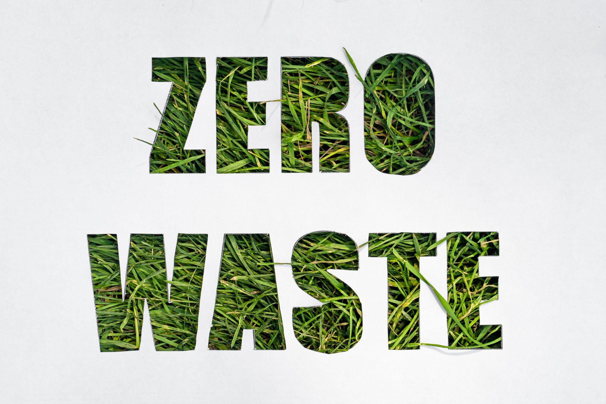 zero waste paper text with green grass on white background