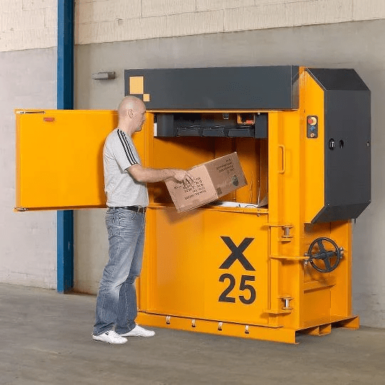 Man using a cardboard baler